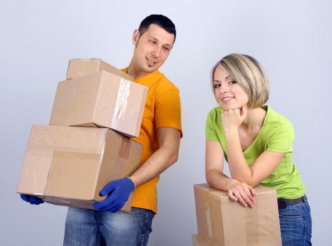 Boxes and furniture being loaded into a moving truck