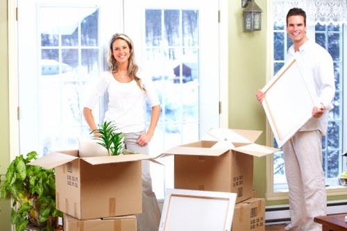 Professional movers loading a van for a North West London move