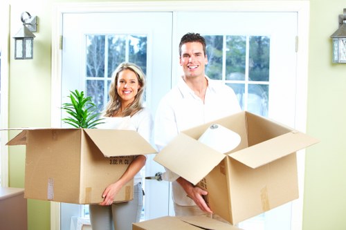 Crew separating cardboard, wood, and reusable items during a move